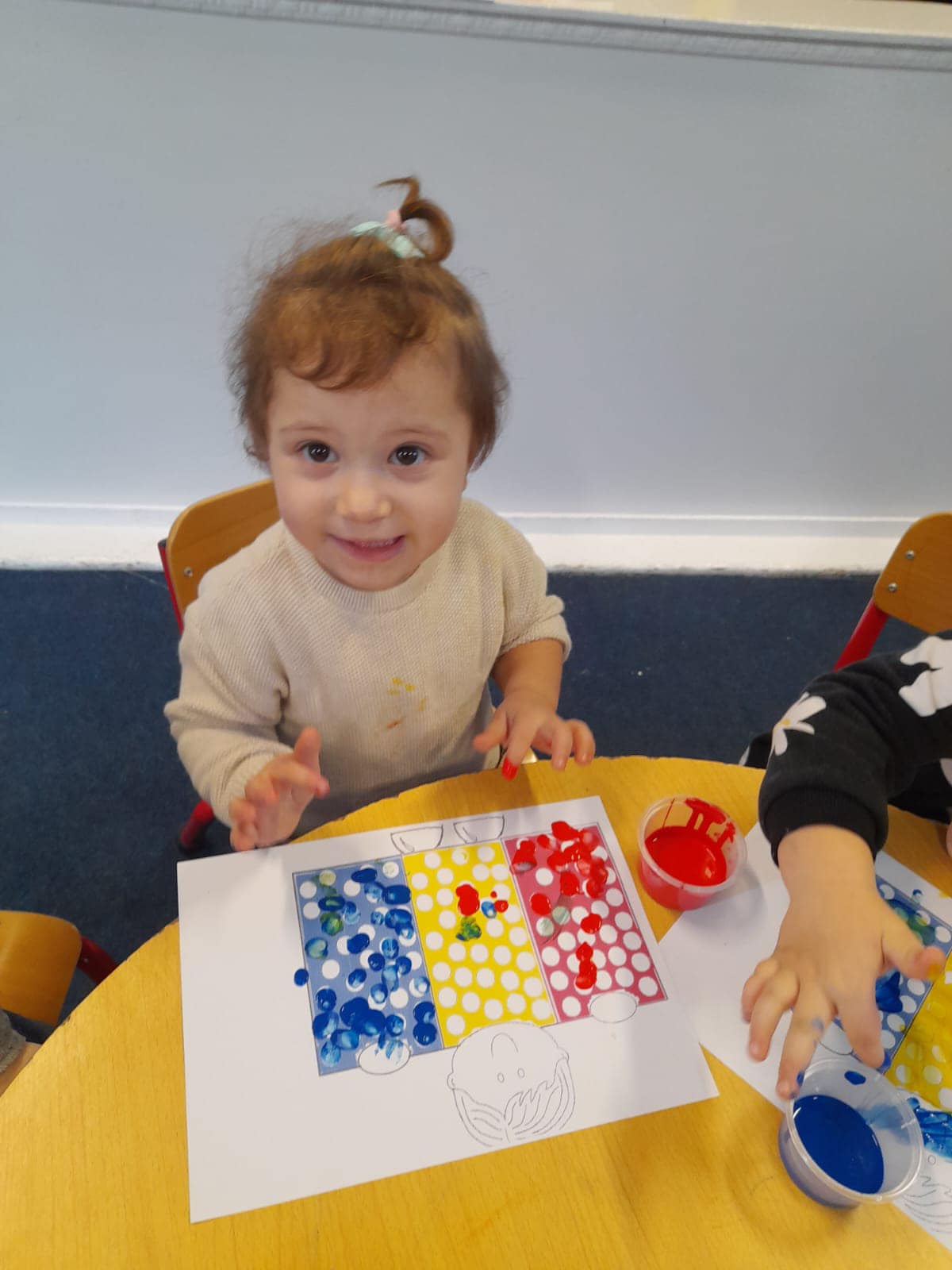 Babies enjoying sensory play in our bright baby room